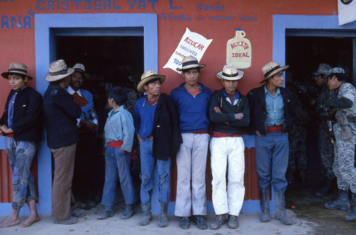 Mayan men leaning on a store wall, Chajul, 1982