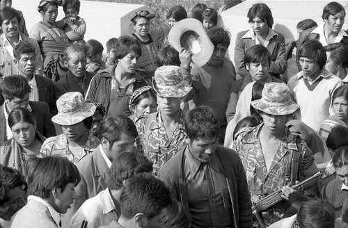 Soldiers stand at a funeral surrounded by civilians, Chimaltenango, 1982