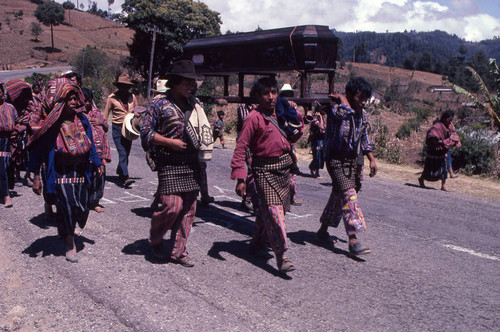 Mayan civilians carrying a coffin to the cemetery, Patzún, 1982