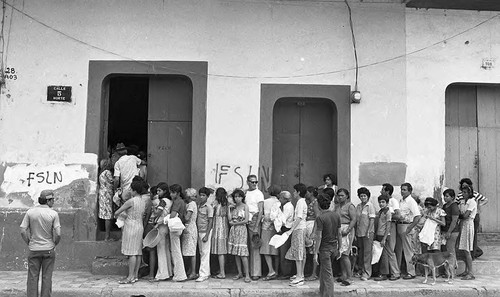 People line up outside of a building, Leon, 1979