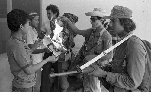 Sandinistas burning photos of Anastasio Somoza Debayle and Anastasio Somoza Garcia, Nicaragua, 1979