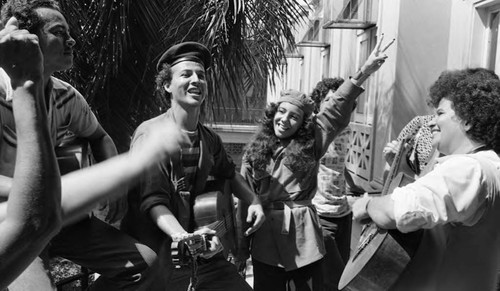 Norma Helena Gadea and other Sandinistas sing to celebrate victory, Managua, 1979