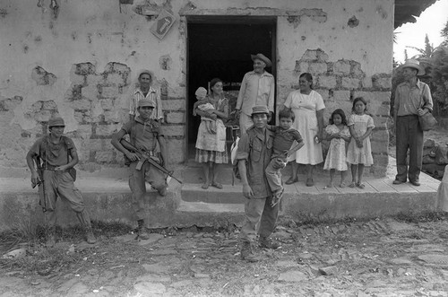 Civilians and army soldiers in front of building, Perquín, 1983