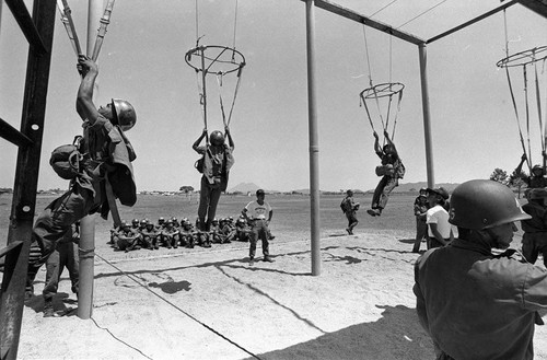 Salvadoran soldiers receiving parachute training at military base, Ilopengo, 1983