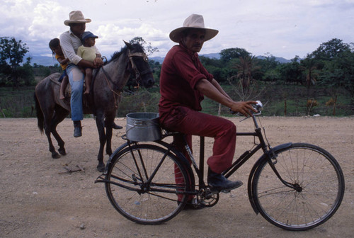 Man on horse and man on bicycle, Honduras, 1983