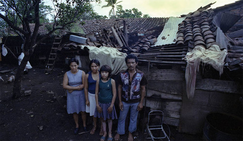 People standing in front of a destroyed home, Managua, 1979