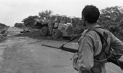 Man looks towards a tractor on a bridge, Nicaragua, 1979