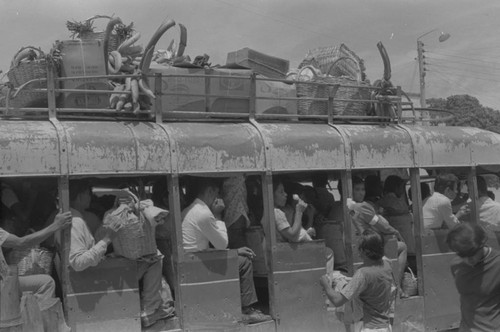 People riding the bus, La Chamba, Colombia, 1976