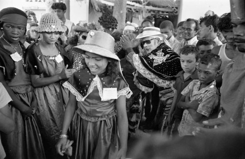 Dancers walking among a crowd, Barranquilla, Colombia, 1977