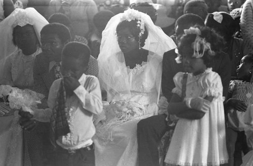 Two grooms and two brides inside a church, San Basilio de Palenque, 1975