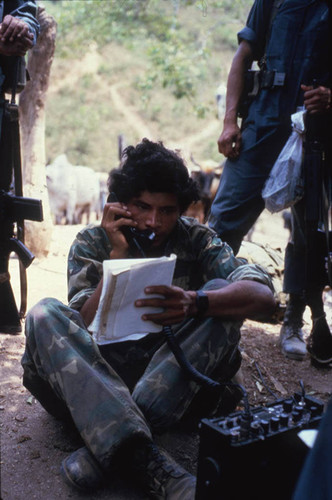 Contra soldier sits on the ground, Nicaragua, 1983