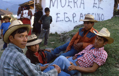 Mayan men rest near graffiti, Chajul, 1982