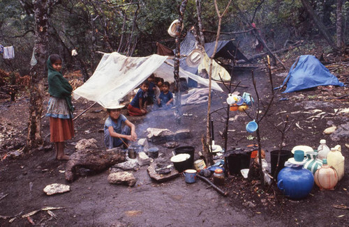 Guatemalan refugee children sit under a tent, La Sombra, 1983