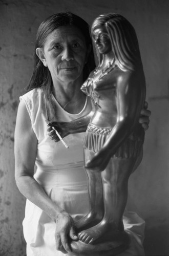 Woman and a statue, La Chamba, Colombia, 1975