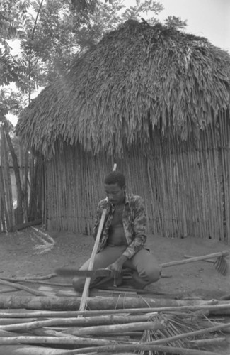 Man smoothing wood, San Basilio de Palenque, 1977