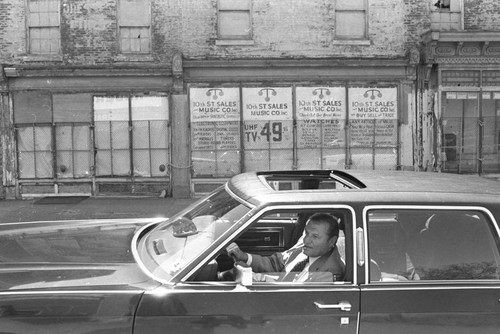 Frank Rizzo drives along street, Philadelphia, ca. 1980