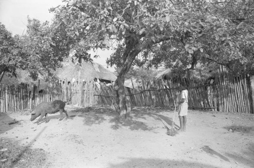 Woman sweeping in a courtyard, San Basilio de Palenque, 1976