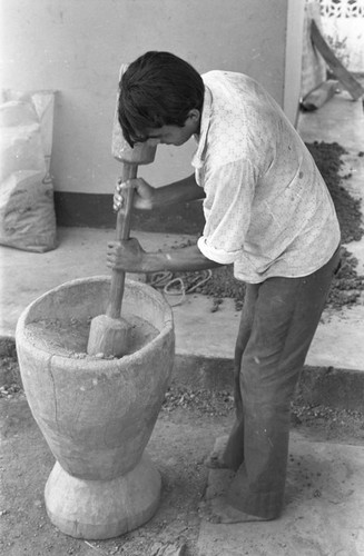 Man using the mortar and pestle, La Chamba, Colombia, 1975