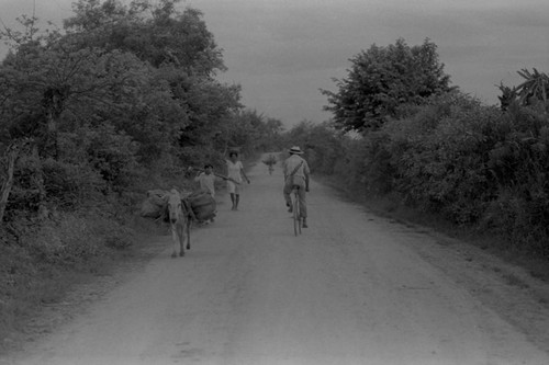 People walking on a dirt road, La Chamba, Colombia, 1975