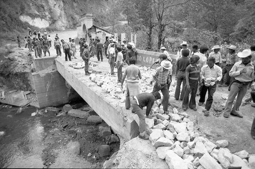 Civilians repairing a crumbling bridge, Chichicastenango, 1982