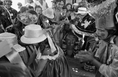 Dancer walking among a crowd, Barranquilla, Colombia, 1977