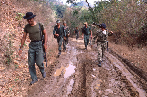 Soldiers walking on a dirt road, San Antonio de los Ranchos, Chalatenango, El Salvador, 1981