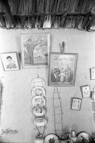 Paintings and dishes hanging from the wall, San Basilio de Palenque, 1976