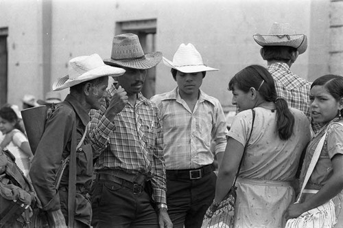 Guerrilleros speak with women, Corinto, Morazán, 1983