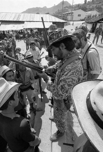 An unidentified soldier inspects a shotgun, Chajul, 1982