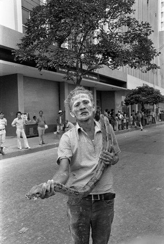 Man holding a snake, Barranquilla, Colombia, 1977