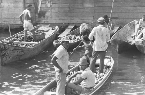 Men on boats loaded with fruits, Cartagena Province, 1975