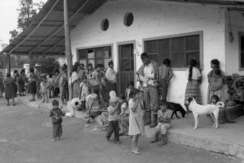 Refugees wait outside a clinic building, Chiapas, 1983