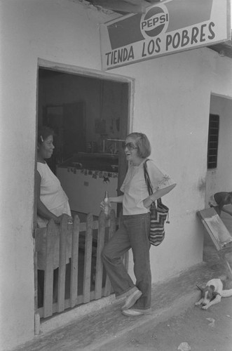 Nina S. de Friedemann and woman talking at doorway, San Basilio de Palenque, ca. 1978