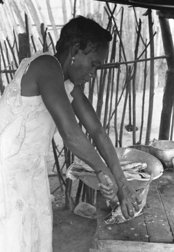 Woman cleaning fish, San Basilio de Palenque, 1975