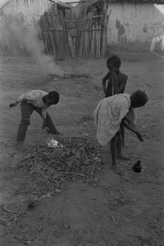 Children playing with a small fire in the street, San Basilio de Palenque, ca. 1978