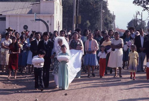 Young bride and groom with wedding attendees, Chiquimula, 1982