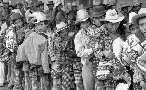 Mayan men wait in line to vote, Guatemala City, 1982