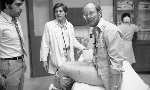 Man sitting on medical clinic bed, Guatemala, 1982