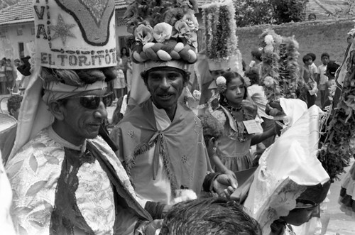 Men in costume walking to the Carnival, Barranquilla, Colombia, 1977