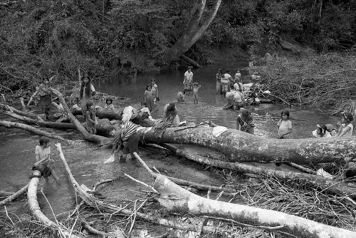 Refugee women and girls wash their clothes at a river, Chiapas, 1983