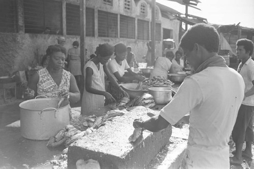 Men and women cleaning fish at city market, Cartagena Province, ca. 1978