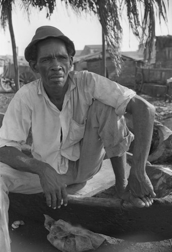 Man sitting at city market, Cartagena Province, ca. 1978