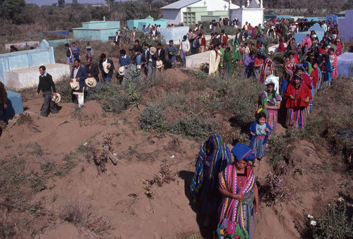 Mayan civilians walking through a cemetery, Patzún, 1982