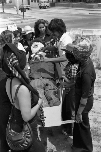 Men and women holding a mannequin in a coffin, Barranquilla, Colombia, 1977