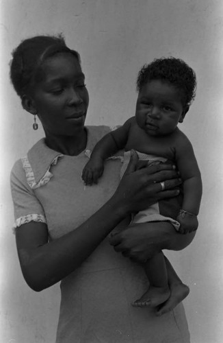 Woman holding a child in her arms, San Basilio de Palenque, 1975