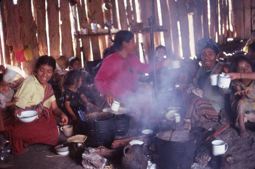 Guatemalan refugees cook and eat, Cuauhtémoc, 1983