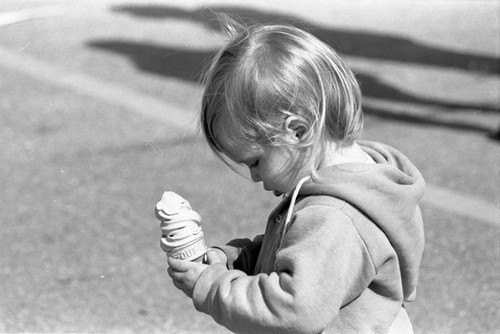 Toddler holding ice cream cone