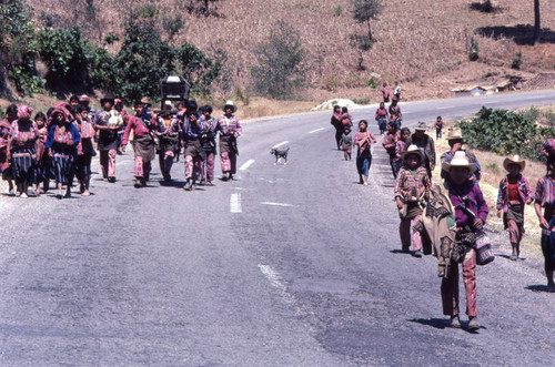 Mayan civilians walk to cemetery carrying a coffin, Patzún, 1982