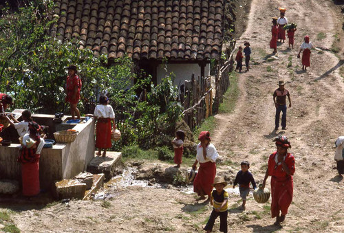 Women and children walk to and from the water well, Chajul, 1982