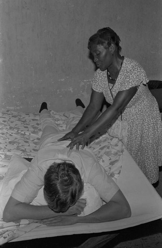 Woman giving a massage to a visitor, San Basilio de Palenque, ca. 1978